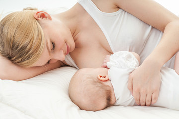 young mother breastfeeds her baby. breast-feeding.