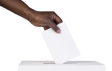 ballot box with person casting vote on blank voting slip