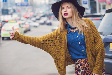 Fashionable young woman posing outside in a city street. Winter Fashion