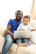 © Africa Studio - Father and son on sofa in the room