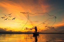 Fisherman Fishing At Lake In Morning, Thailand.