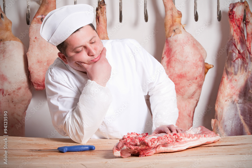 Candid portrait capturing the essence of a butcher at work showcasing a piece of meat on his table offering a glimpse into the craftsmanship and dedication of the profession
