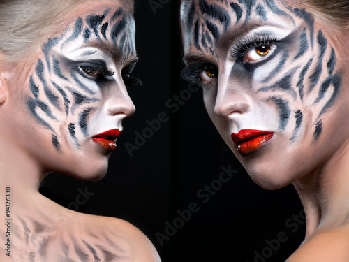 Obraz w ramie Woman with tiger face in halloween concept