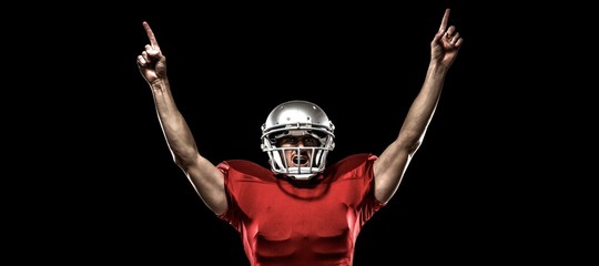 Canvas Print - American football player with arms raised cheering