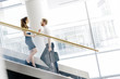 © NDABCREATIVITY - Business colleagues talking on stairs