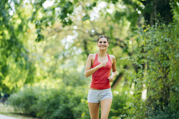 Young beautiful athlete jogging in park