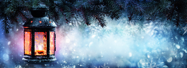 Wall Mural - christmas lantern on snow with fir branch