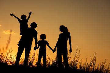 Canvas Print - Happy family standing in the park.