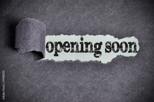 Fotografía opening soon word under torn black sugar paper
