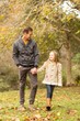 © WavebreakMediaMicro - Happy father and daughter walking together in park