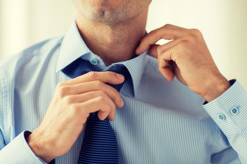 Sticker - close up of man in shirt adjusting tie on neck