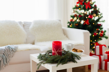 sofa, table and christmas tree with gifts at home