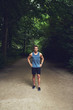 © Flamingo Images - Athletic young man standing waiting in a park