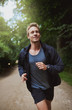 © Flamingo Images - Healthy young man jogging through a park