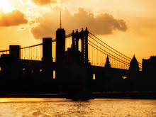 Silhouette Of The Downtown Manhattan Skyline And The Manhattan Bridge At Sunset