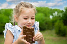 Joyful Girl Eating Chocolate