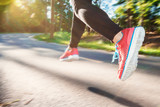 Woman jogging down an outdoor trail