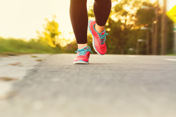 Woman runner jogging down an outdoor path