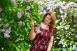 © olgavolodina - Middle-aged woman near blossoming lilac