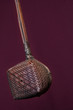 Bamboo Tea Strainer - A close up of a bamboo tea strainer against a red background