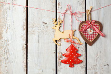 Christmas background with rustic decorations over white wooden board