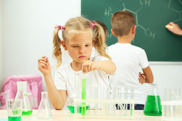 Wall Mural - Cute pupils doing biochemistry research in chemistry class