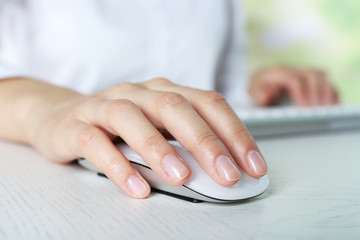 Canvas Print - Female hand with computer mouse on table, closeup