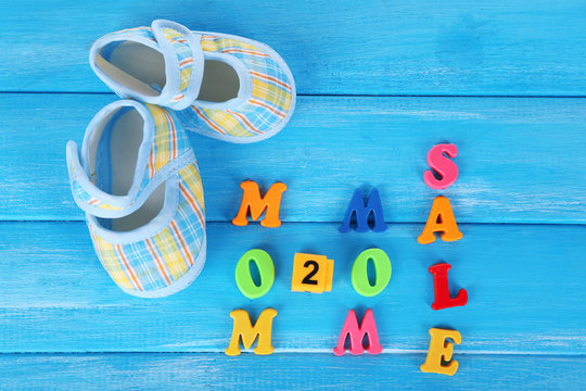Concept of childish goods sale  on blue wooden background