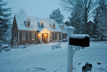 Cozy Williamsburg-style House In The Snow On A Winter Evening In December During The Christmas/Holiday Season