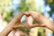 © Africa Studio - Hands in shape of love heart on nature background