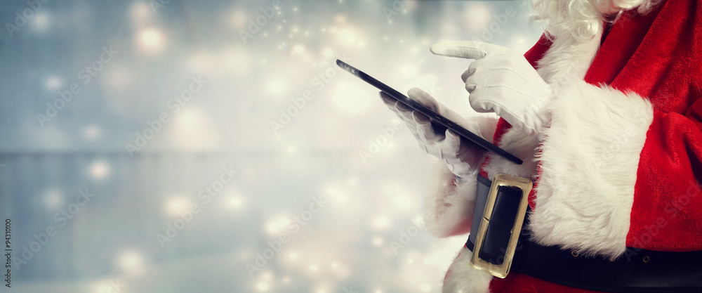 Santa Claus using a tablet Stock Photo | Adobe Stock