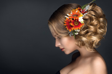 Beautiful woman portrait with autumn flowers in hair