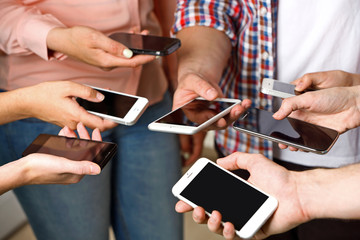 Poster - Many hands holding mobile phones close up