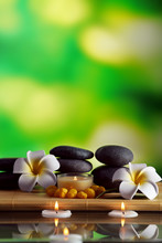 Still Life With Spa Stones On Green Blurred Background