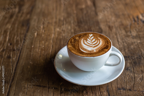 Fototapeta na wymiar Latte Art on Wooden Background