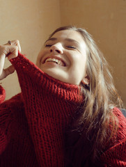 Wall Mural - young pretty real woman in sweater and scarf all over her face