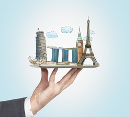a man's hand holds a tablet with sketches of the most famous places in italy, great britain, france 