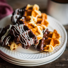 Wall Mural - Belgian waffles with chocolate on rustic wooden background