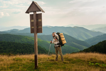 Tourist looks at wooden pointer