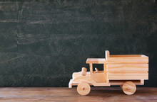 Photo Of Wooden Toy Truck In Front Of Chalkboard
