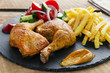roasted chicken legs with french fries and salad