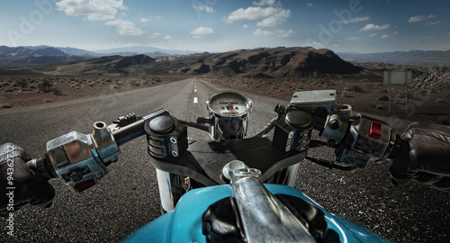 Fotografija  Man driving on moto on big speed on mountain road