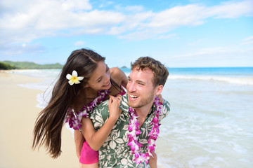 Wall Mural - Beach couple having fun laughing on Hawaii holiday