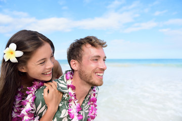 Wall Mural - Beach couple having fun piggybacking Hawaii travel