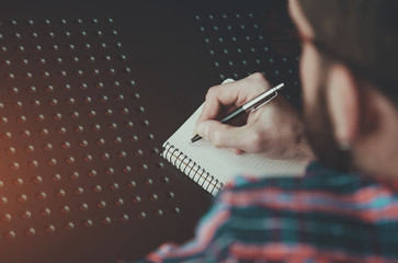 Wall Mural - bearded man writing with pen in notebook