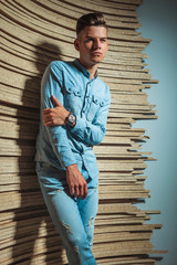 Wall Mural - man in denim posing in studio while touching his arm