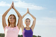 © LENSLOGIC - Two beautiful girls meditating outdoors