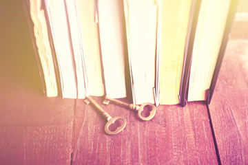Poster - Some books with old style keys on a wooden table, instagram phot