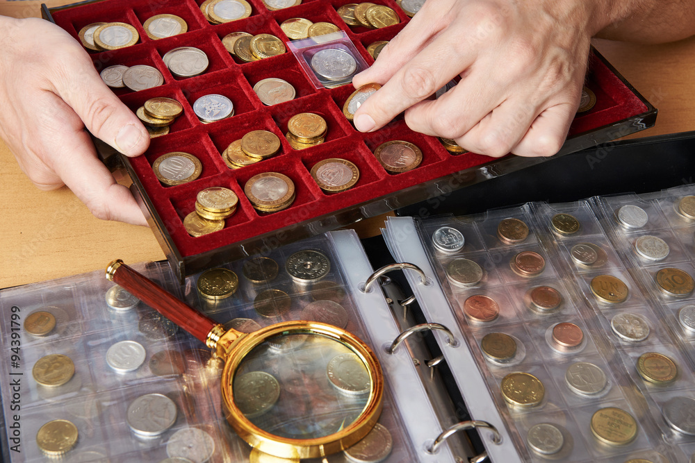 Numismatist with his collection of coins - obrazy, fototapety, plakaty 