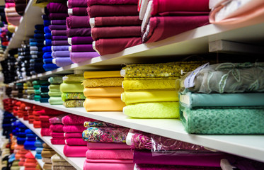 Wall Mural - Rolls of fabric and textiles in a factory shop or  store